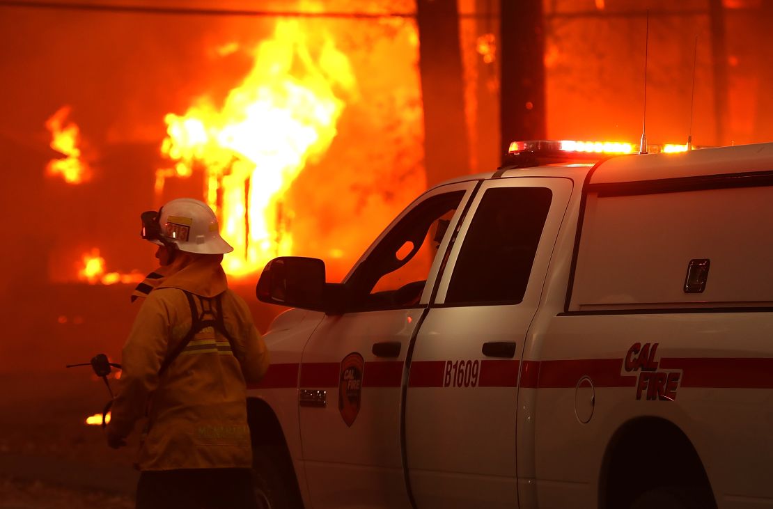 A firefighter monitors a burning home as the Camp Fire moves through Paradise, California, on November 8, 2018.