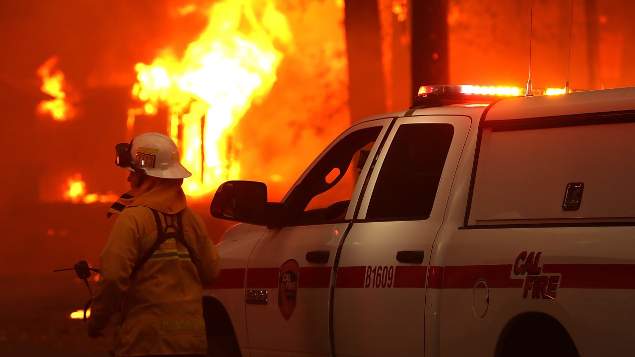 A firefighter monitors a burning home as the Camp Fire moves through Paradise, California, on November 8, 2018.