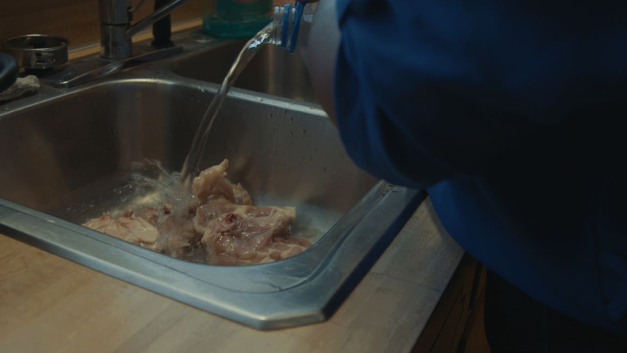 Denmark, South Carolina, resident Deanna Berry uses bottled water to clean chicken for her family's dinner.