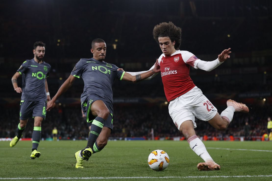 Sporting's Portuguese forward Carlos Mane vies for the ball with Arsenal's French midfielder Matteo Guendouzi.