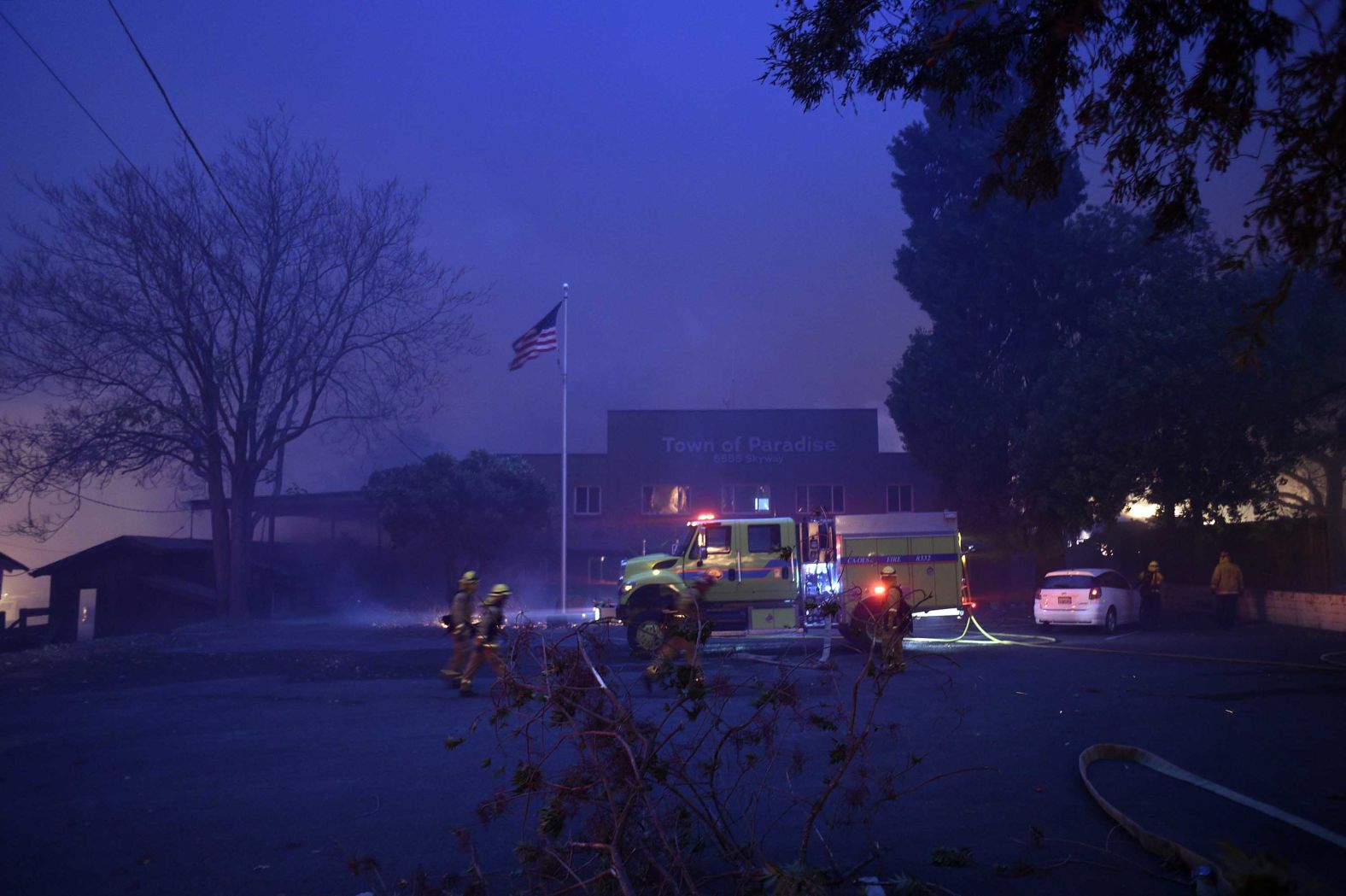 A fire emergency crew works to protect the Paradise Town Hall from the encroaching Camp Fire on November 8.