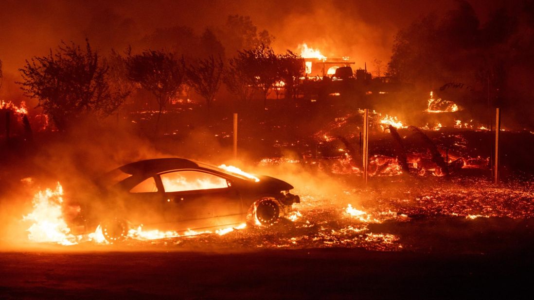 Vehicles and homes burn as the Camp Fire rips through Paradise on November 8.