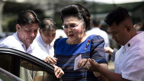Imelda Marcos is assisted to her car after visiting her husband's tomb, August 28, 2017. 