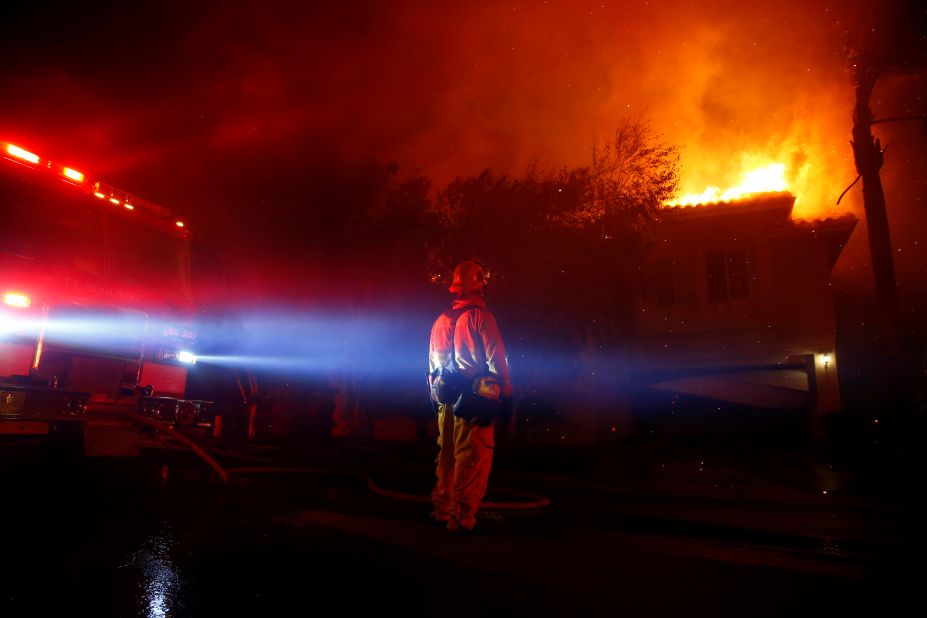 Firefighters battle flames in Thousand Oaks early on November 9.