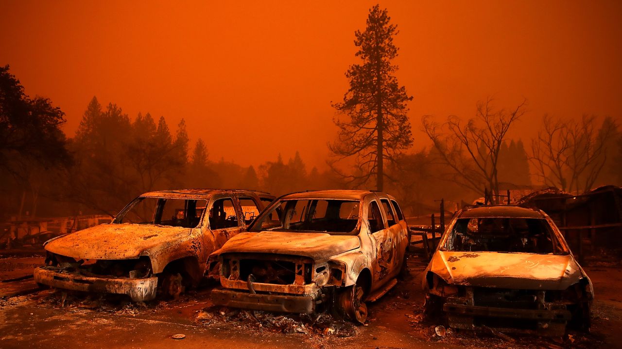 Scorched cars sit on a used car lot during the Camp Fire in 2018.