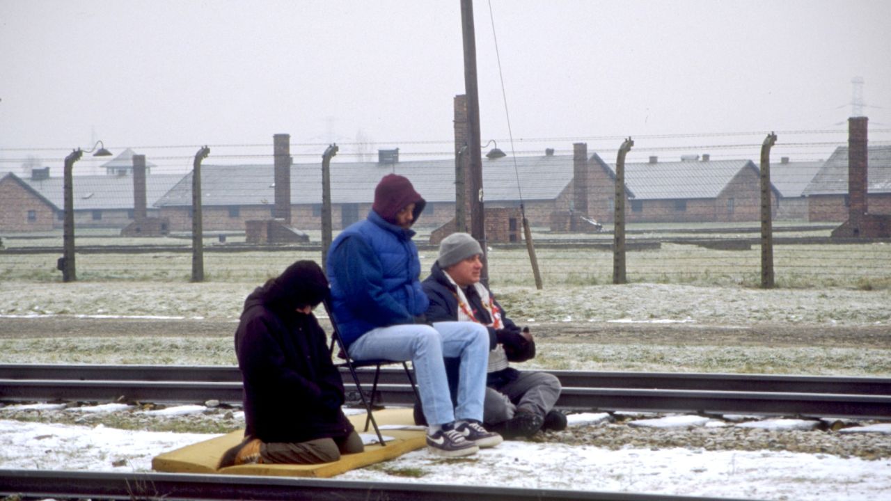 Glassman and other Zen Peacemakers meditate on the train tracks at Auschwitz. Photograph by Peter Cunningham.  