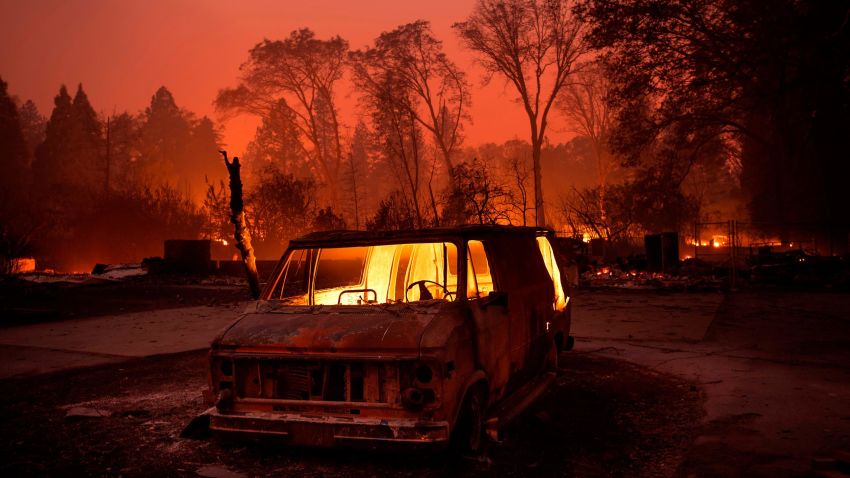 Flames burn inside a van as the Camp Fire tears through Paradise, Calif., on Thursday, Nov. 8, 2018. Tens of thousands of people fled a fast-moving wildfire Thursday in Northern California, some clutching babies and pets as they abandoned vehicles and struck out on foot ahead of the flames that forced the evacuation of an entire town and destroyed hundreds of structures. (AP Photo/Noah Berger)