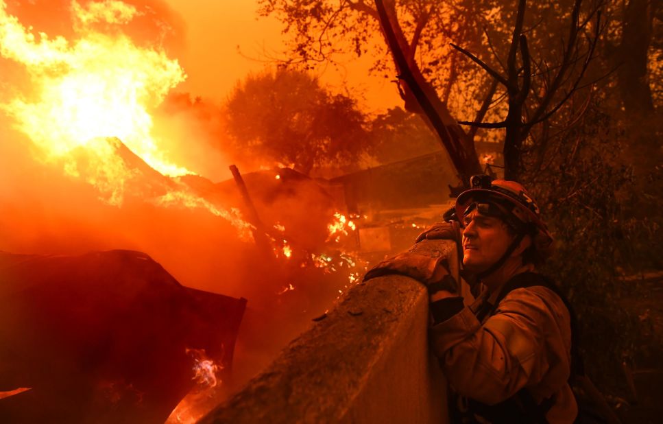 Malibu Mayor Rick Mullen, who is also a firefighter, surveys a house engulfed in flames on Friday, November 9.