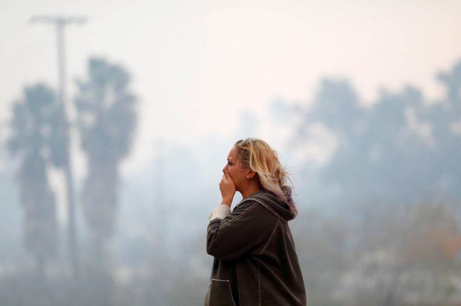 A woman in Malibu reacts to devastation on November 9.
