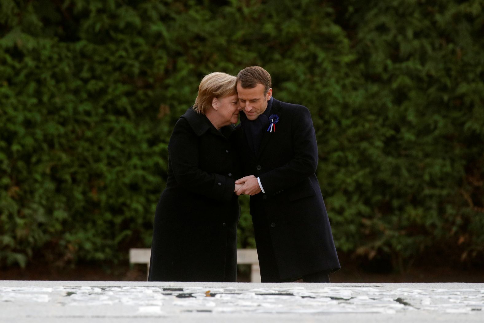 French President Emmanuel Macron and German Chancellor Angela Merkel hug after unveiling a plaque in the Clairiere of Rethondes during a commemoration ceremony on November 10 for Armistice Day, 100 years after the end of the First World War, in Compiegne, France.