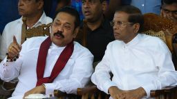 Sri Lanka's President Maithripala Sirisena (R) and newly appointed prime minister Mahinda Rajapaksa speak during a rally in Colombo on November 5 (Photo by LAKRUWAN WANNIARACHCHI / AFP)   