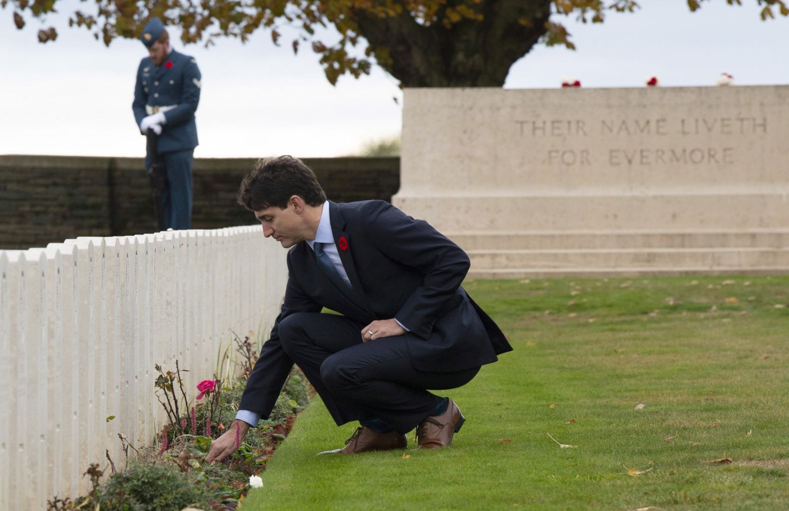 Canadian Prime Minister Justin Trudeau places a flower at a gravestone as he tours the Canadian Cemetery No. 2 near Vimy Ridge, France, on November 10.