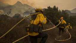 MALIBU, CA - NOVEMBER 10: Los Angeles County firefighters attack flames approaching the Salvation Army camps in Malibu Creek State Park during the Woolsey Fire on November 10, 2018 near Malibu, California. The Woolsey fire has burned over 70,000 acres and has reached the Pacific Coast at Malibu as it continues grow.   (Photo by David McNew/Getty Images)