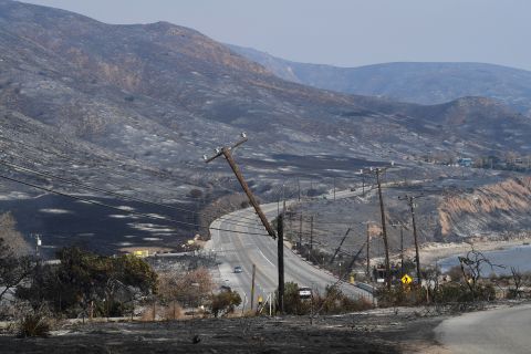 Scorched hillsides and damaged power lines are seen on November 10 along the Pacific Coast Highway in Malibu.