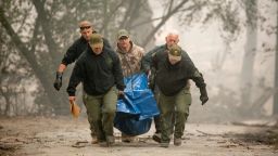 Yuba County Sheriff officers carry a body away from a burned residence in Paradise, California, on November 10, 2018. - Firefighters in California on November 10 battled raging blazes at both ends of the state that have left at least nine people dead and thousands of homes destroyed, but there was little hope of containing the flames anytime soon. So far, all nine fatalities were reported in the town of Paradise, in Butte County, where more than 6,700 buildings, most of them residences, have been consumed by the late-season inferno, which is now California's most destructive fire on record. (Photo by Josh Edelson / AFP)        (Photo credit should read JOSH EDELSON/AFP/Getty Images)