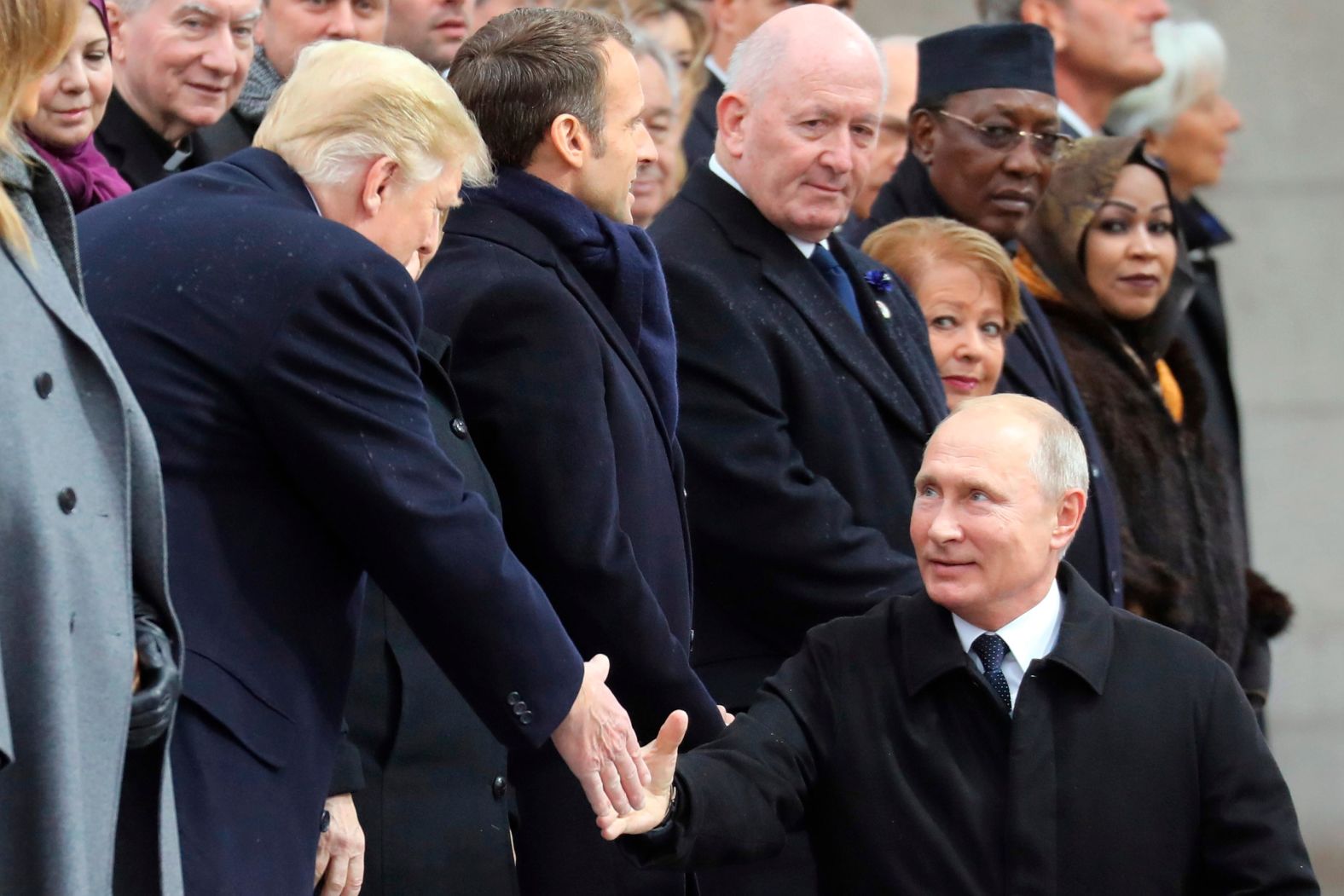 Russian President Vladimir Putin shakes hands with US President Donald Trump as he arrives to attend a ceremony at the Arc de Triomphe in Paris on Sunday. 