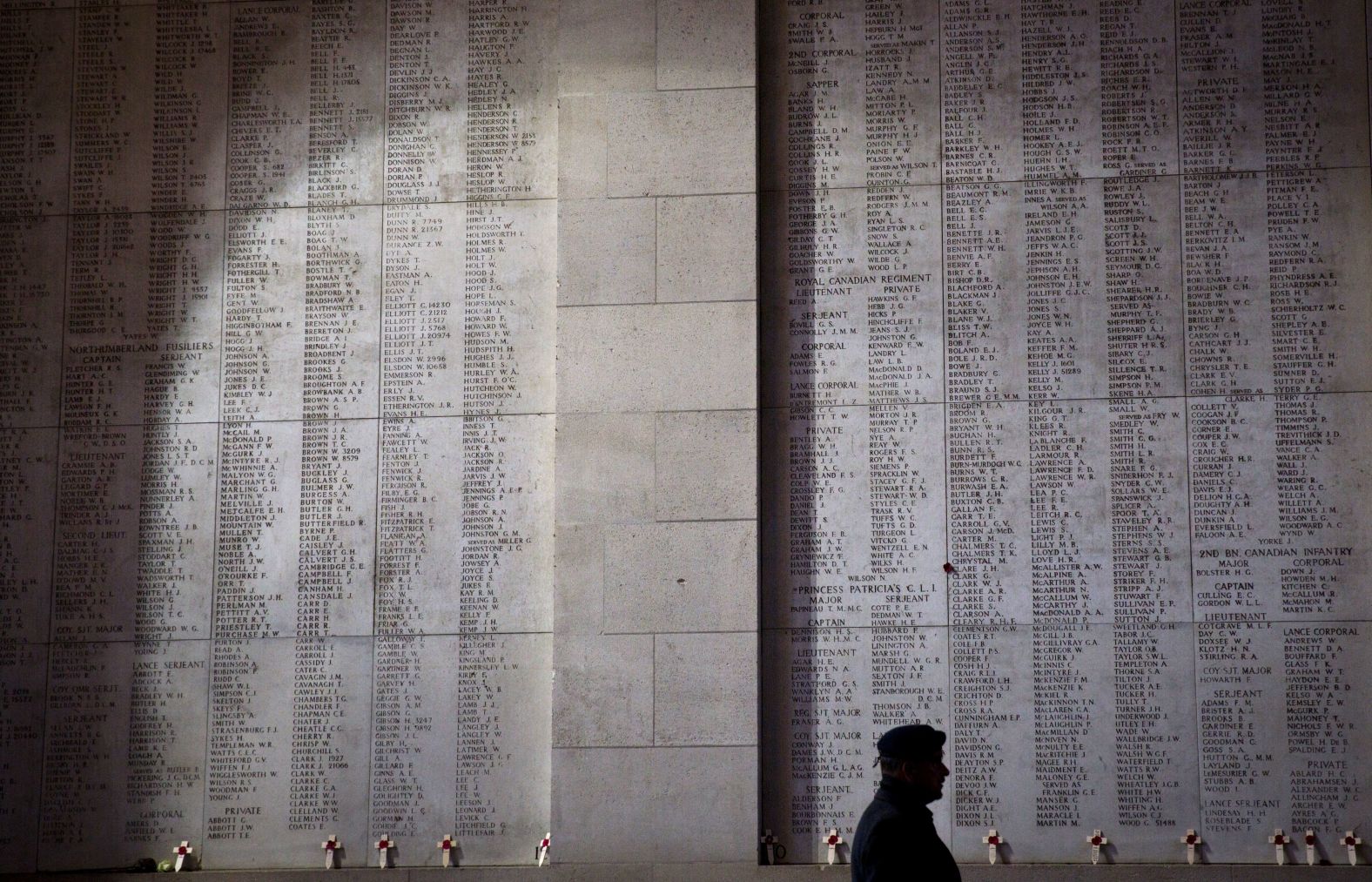 A soldier walks by wooden crosses and names of the missing during an Armistice ceremony at the Menin Gate in Ypres, Belgium on Sunday.