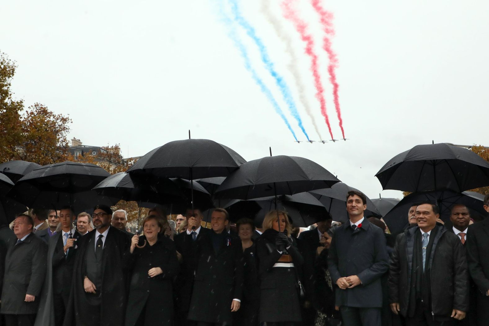 Denmark's Prime Minister Lars Lokke Rasmussen, Morocco's Prince Moulay Hassan, Moroccan King Mohammed VI, German Chancellor Angela Merkel, French President Emmanuel Macron and his wife Brigitte Macron, and Canadian Prime Minister Justin Trudeau arrive at the Arc de Triomphe in Paris on Sunday.