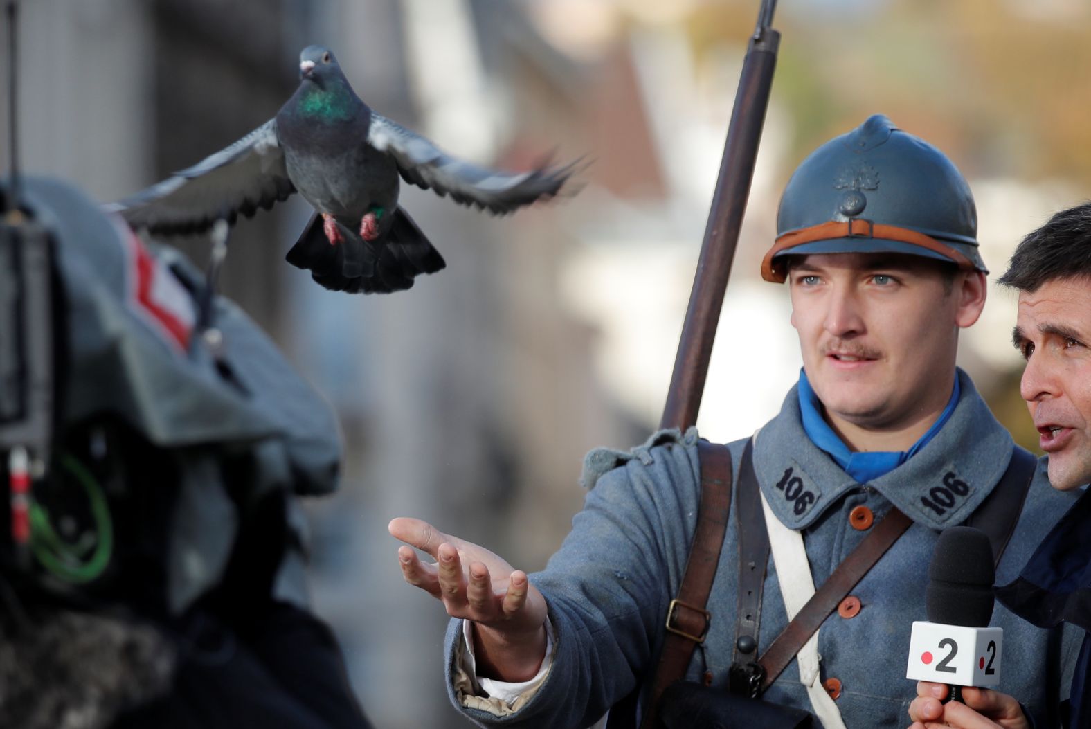 A history enthusiast dressed as a French soldier delivers a pigeon during a commemoration ceremony for Armistice Day in Epernay, France on Sunday.