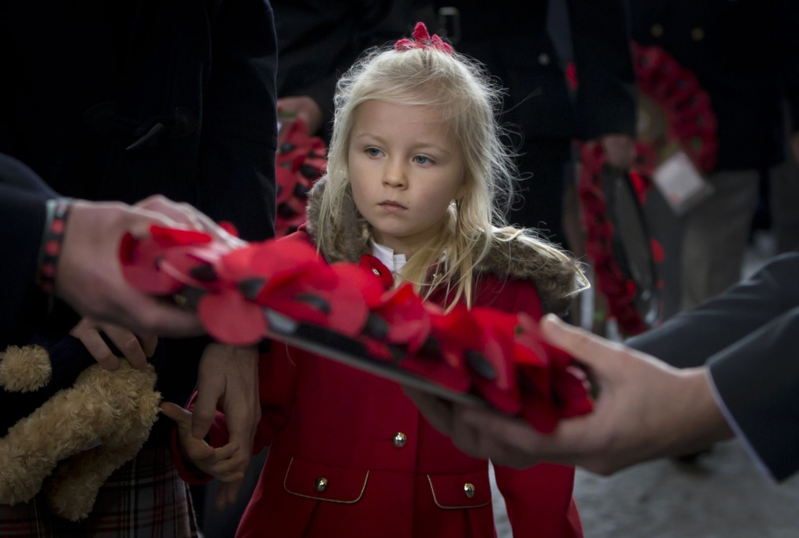 A  girl prepares to lay a poppy wreath during an Armistice ceremony at the Menin Gate in Ypres, Belgium on Sunday.