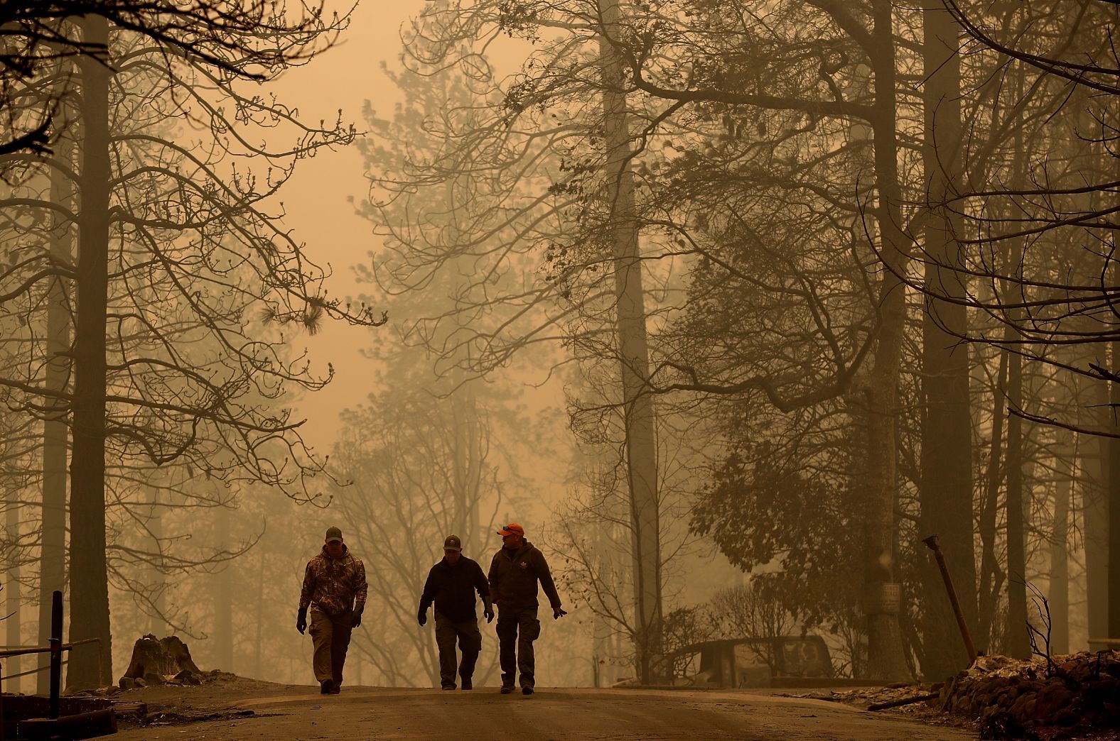 Sheriff's deputies walk November 10 through a neighborhood destroyed by the Camp Fire.