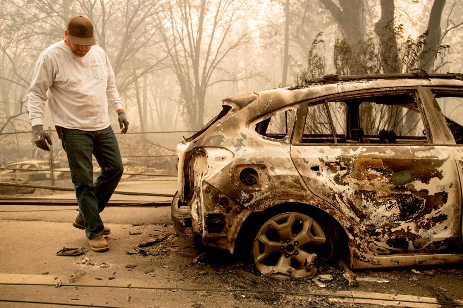 Eric England searches through a friend's vehicle in Paradise on November 10.