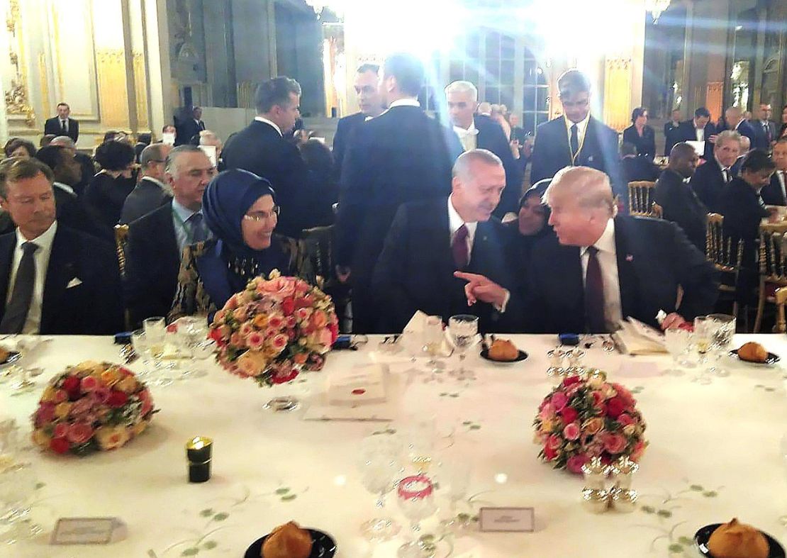  US President Donald Trump and Turkish President Recep Tayyip Erdogan sitting next to each other and chatting at a dinner hosted by French President Emmanuel Macron on November 10 2018 in Paris.