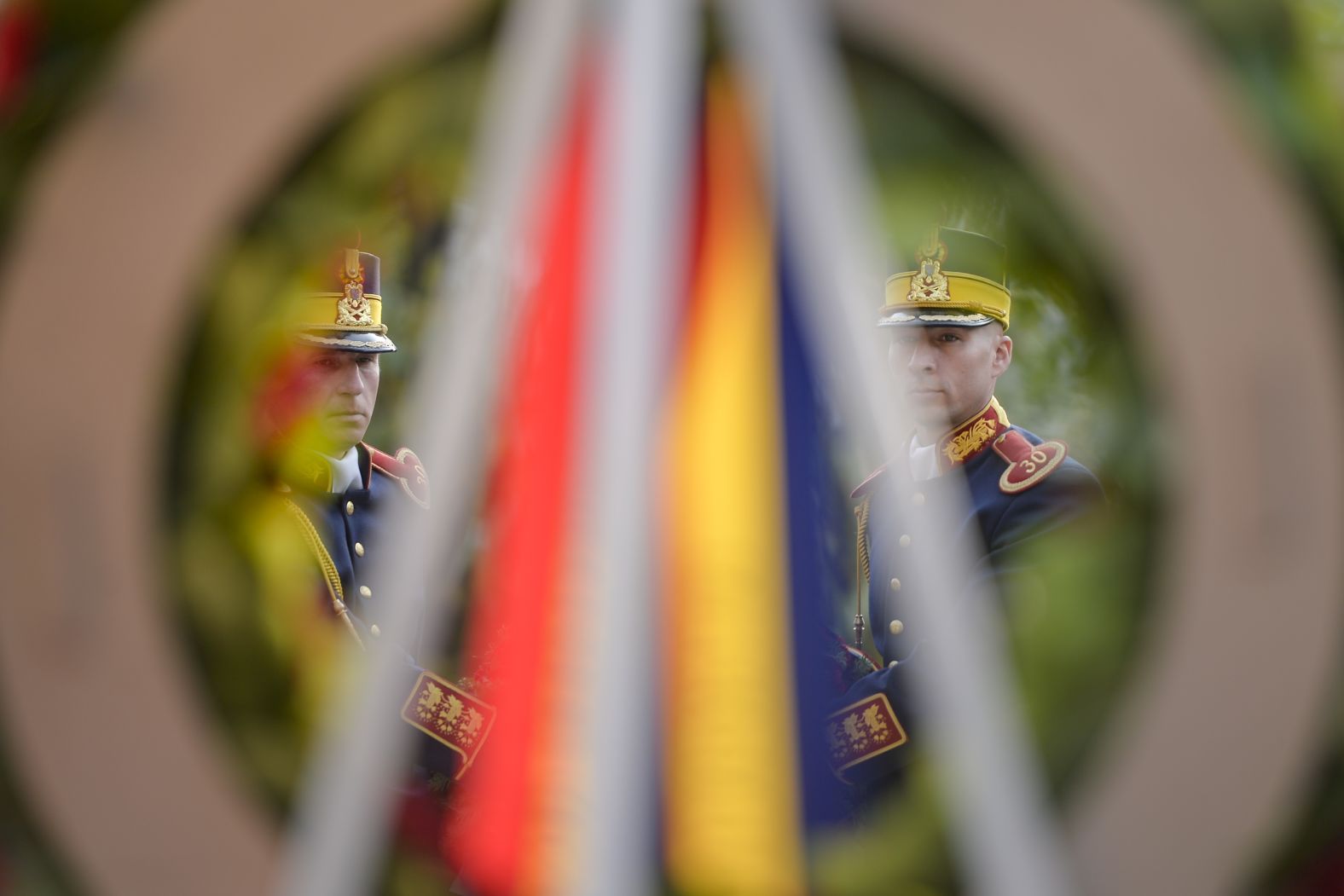 Honor guards in Bucharest on Sunday carry a wreath to a monument to French soldiers killed in Romania during World War I.