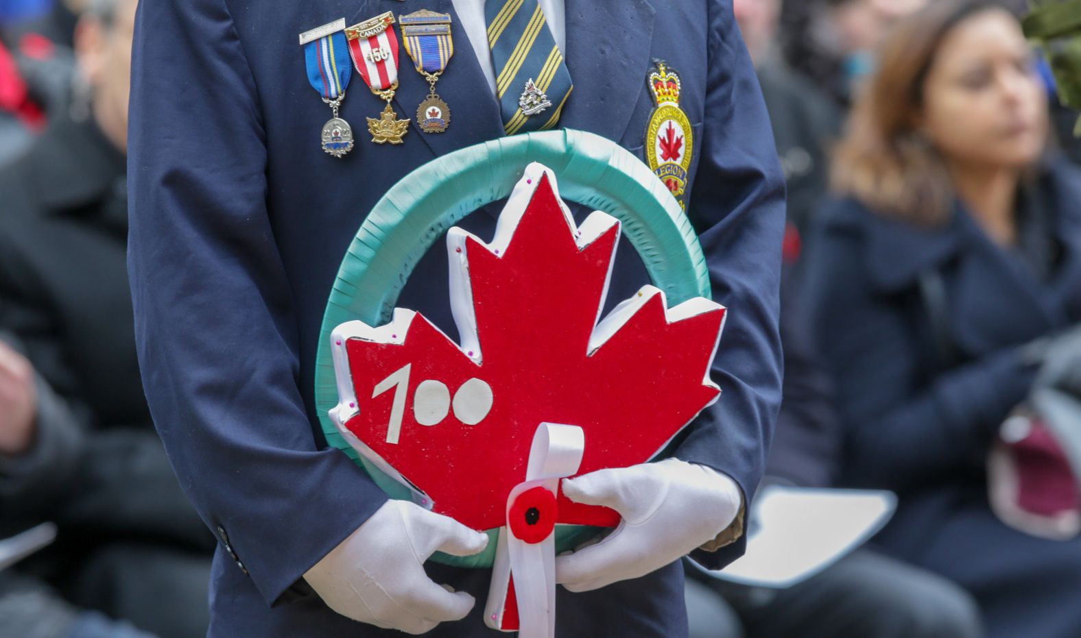A veteran holds a wreath during a ceremony Sunday in Toronto.
