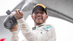 Race winner Lewis Hamilton of Great Britain and Mercedes GP celebrates on the podium after winning the Brazilian GP>