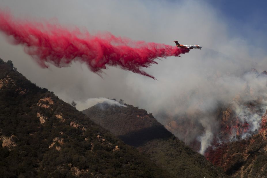 A plane drops fire retardant on a burning hillside in Malibu on November 11.