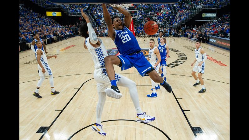 Duke center Marques Bolden dunks against Kentucky forward Nick Richards during the State Farm Champions Classic basketball game on November 6 at Bankers Life Fieldhouse in Indianapolis, Indiana. The 4th ranked Blue Devils crushed the 2nd ranked Wildcats 118-84 in the season opener of the NCAA basketball season.