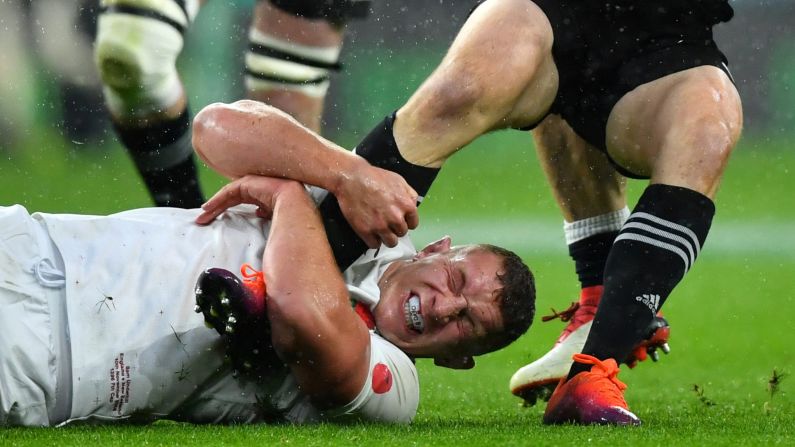 England's Sam Underhill makes a tackle during a rugby match between England and New Zealand on November 10 at Twickenham Stadium in London, England.