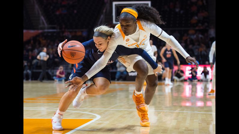 Meme Jackson of the Tennessee Lady Volunteers reaches over Haris Price of the Carson-Newman Eagles during an exhibition game between Carson-Newman and Tennessee on November 5 at Thomson-Boling Arena in Knoxville, Tennessee. The Lady Volunteers won the game 128-59.