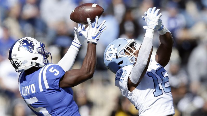 Johnathan Lloyd of Duke attempts to catch a pass while being defended by North Carolina's Corey Bell during their game in Durham, North Carolina on November 10. Duke won the game 42-35 over their in-state rival.