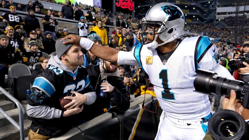 Carolina Panthers quarterback Cam Newton gives a fan a football following a touchdown by Panthers running back Christian McCaffrey during the first quarter against the Pittsburgh Steelers at Heinz Field on November 8. The Steelers won the lopsided matchup 52-21.
