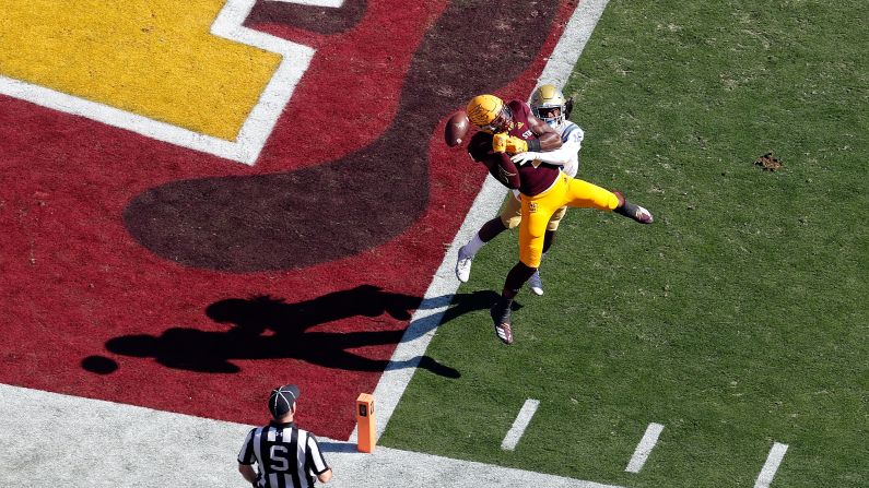 Defensive back Elijah Gates of the UCLA Bruins knocks the ball away from wide receiver N'Keal Harry of the Arizona State Sun Devils during the first half on November 10 at Sun Devil Stadium in Tempe, Arizona.