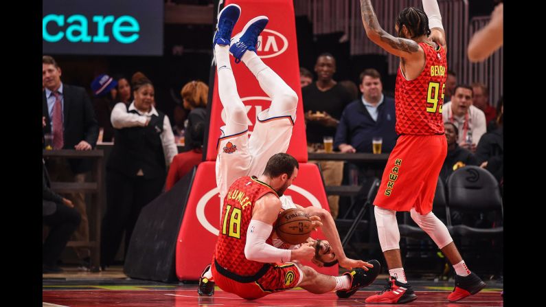 New York Knicks Center Enes Kanter is flipped over Atlanta Hawks center Miles Plumlee during the second half of a game on November 7 at State Farm Arena in Atlanta, Georgia.