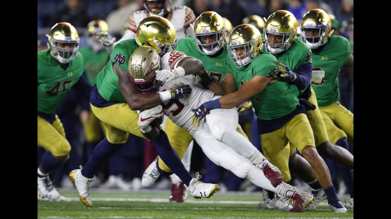Florida State running back Jacques Patrick is brought down by Notre Dame defenders in the second half of a college football game in South Bend, Indiana on November 10. The third ranked Fighting Irish won 42-13 to improve their record to 10-0.