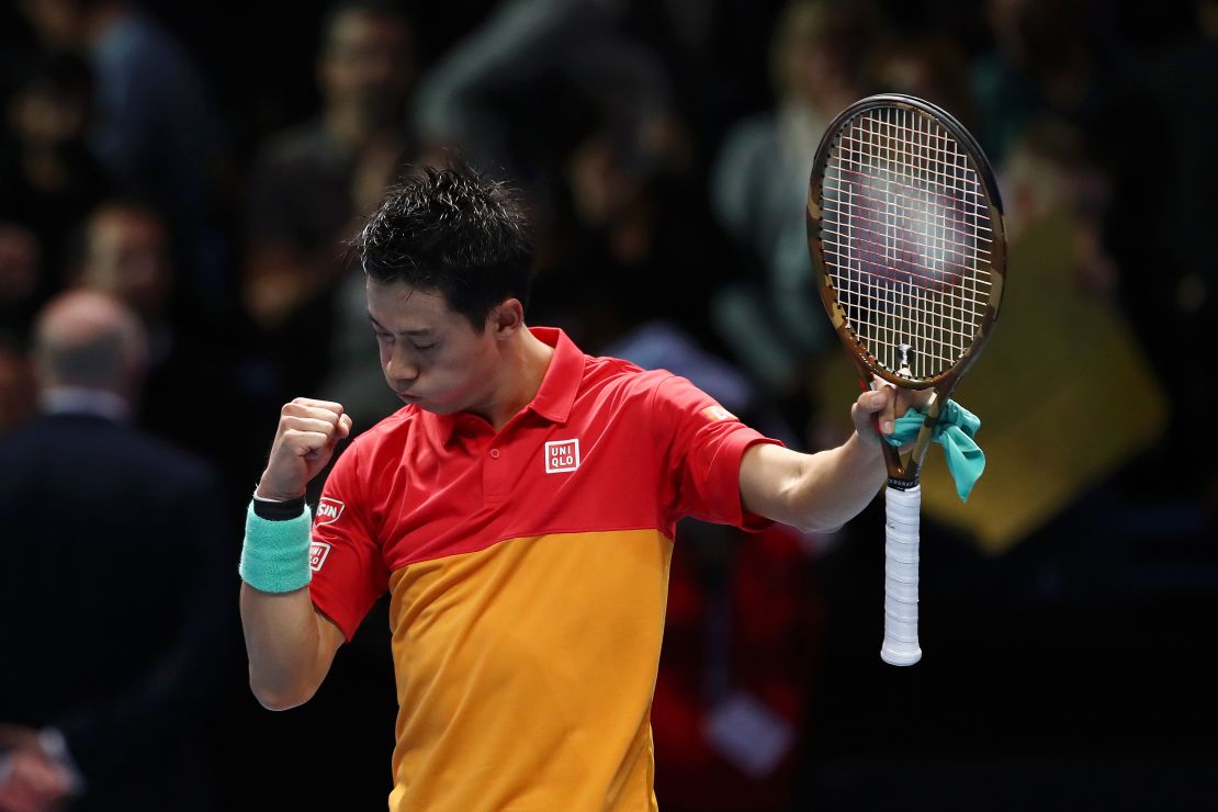 Japan's Kei Nishikori celebrates match point against Roger Federer of Switzerland during Day One of the Nitto ATP World Tour Finals.
