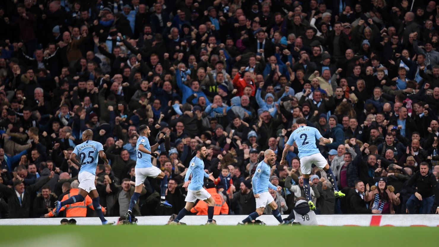 David Silva celebrates with teammates after scoring the first goal during the Manchester derby at the Etihad Stadium.