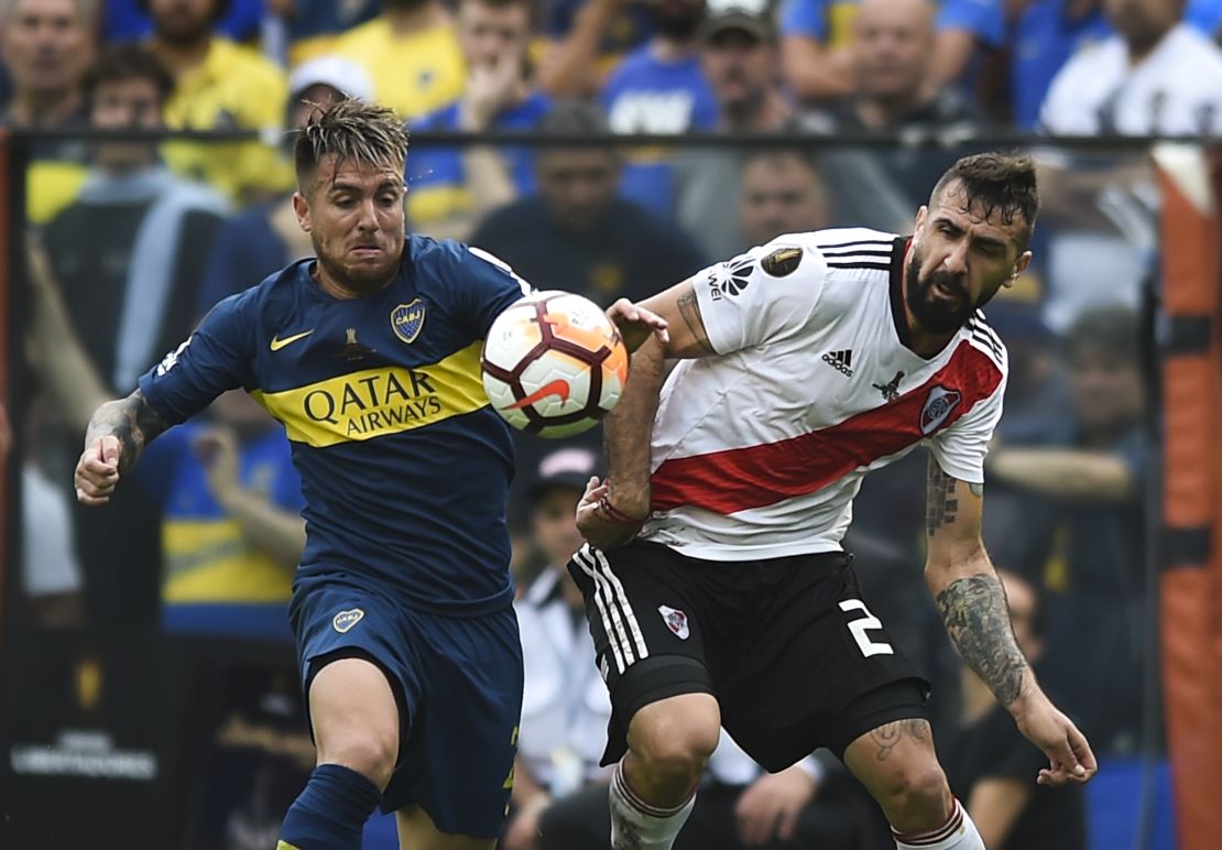 Julio Buffarini of Boca Juniors fights for the ball with River Plate's Lucas Pratto.