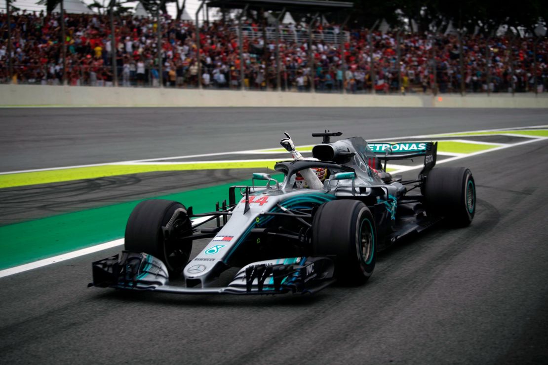 Mercedes' British driver Lewis Hamilton waves from his car after winning the F1 Brazil Grand Prix at the Interlagos racetrack in Sao Paulo, Brazil.