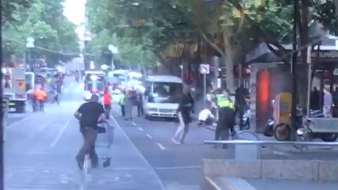 A still taken from video of the attack shows Rogers running with the shopping cart towards the attacker. 