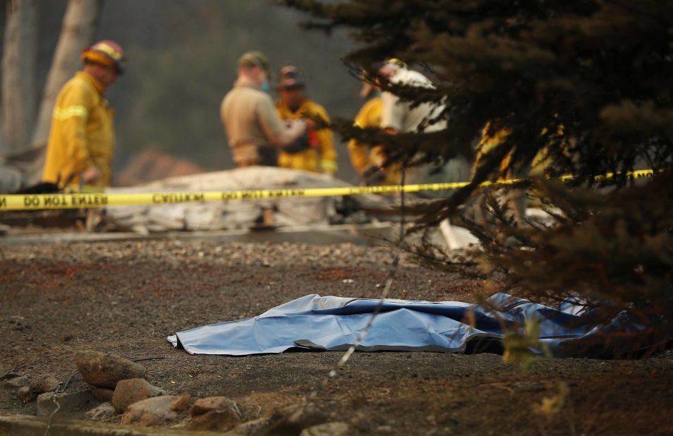 A bag containing human remains lies on the ground on November 11 as officials continue to search for victims at a burned-out home in Paradise.