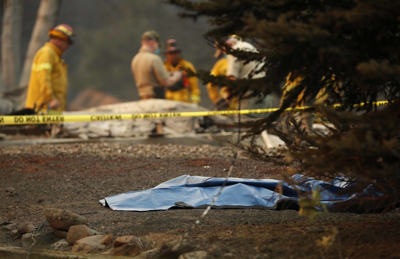A bag containing human remains lies on the ground on November 11 as officials continue to search for victims at a burned-out home in Paradise.