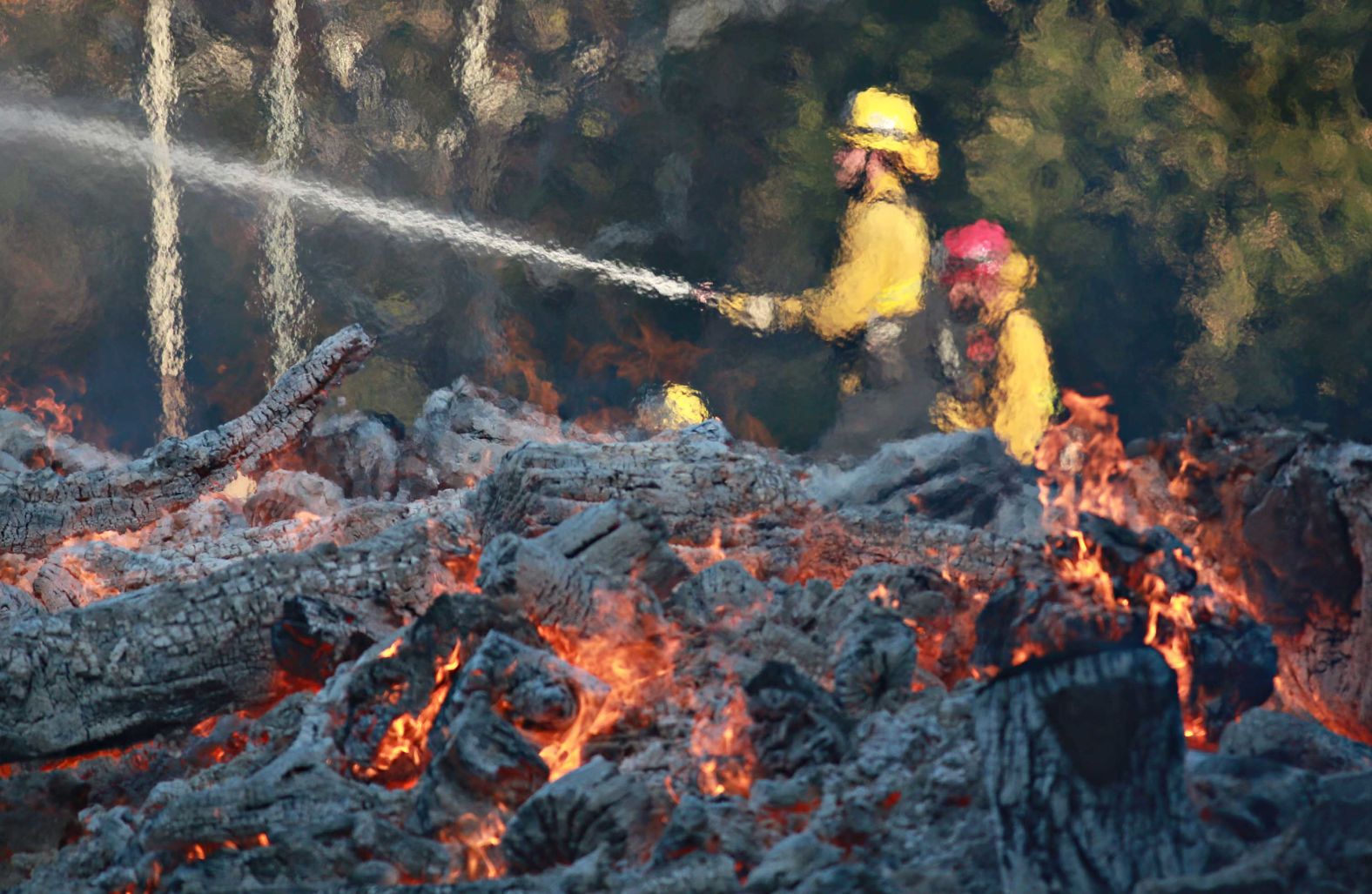 Firefighters work at the Salvation Army Camp in Malibu on Saturday, November 10.