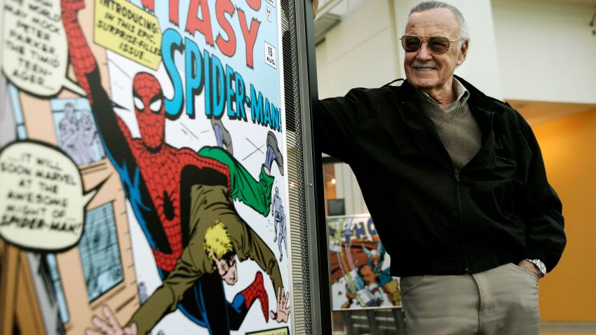 FILE - In this March 21, 2006 file photo, comic book creator Stan Lee stands beside some of his drawings in the Marvel Super Heroes Science Exhibition at the California Science Center in Los Angeles. The Walt Disney Co. on Monday, Aug. 31, 2009 said it is buying Marvel Entertainment Inc. for $4 billion in cash and stock, bringing such characters as Iron Man and Spider-Man into the family of Mickey Mouse and WALL-E.  (AP Photo/Damian Dovarganes, file)