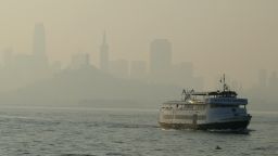 A ferry boat makes its way toward Alcatraz Island as the skyline in the background is obscured by wildfire smoke and haze Monday, Nov. 12, 2018, in San Francisco. (AP Photo/Eric Risberg)