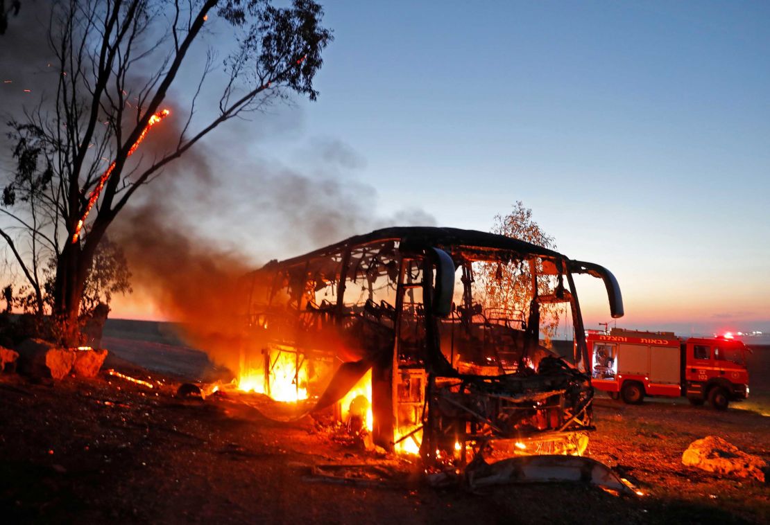 A bus set ablaze after it was hit by a rocket fired from Gaza.
